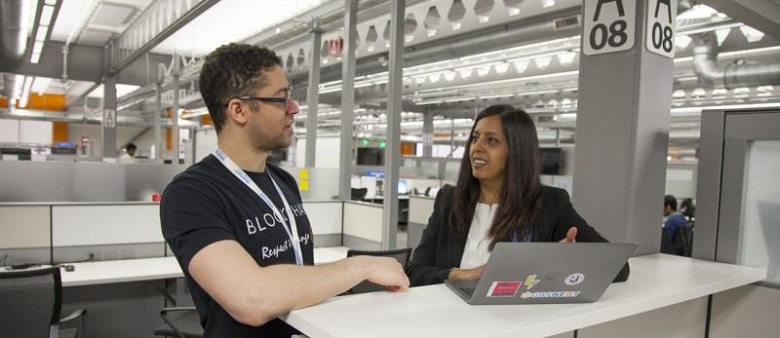 One male Blockchain team member from Walmart speaks with one female blockchain team member from walmart.