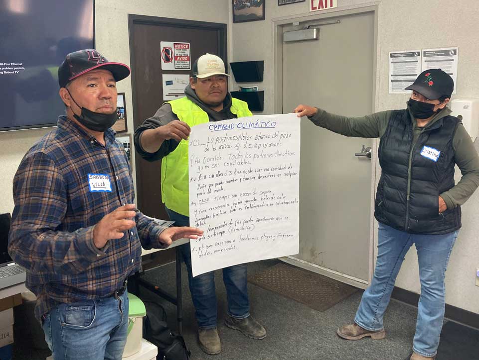  Members of GoodFarms display their training presentation